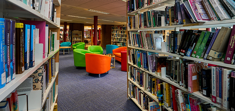 rows of books and colourful chairs rows of books and colourful chairs