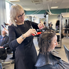 hairdressing student cutting hair